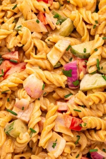 Creamy BBQ pasta salad with rotini, fresh vegetables, and herbs in a creamy BBQ dressing