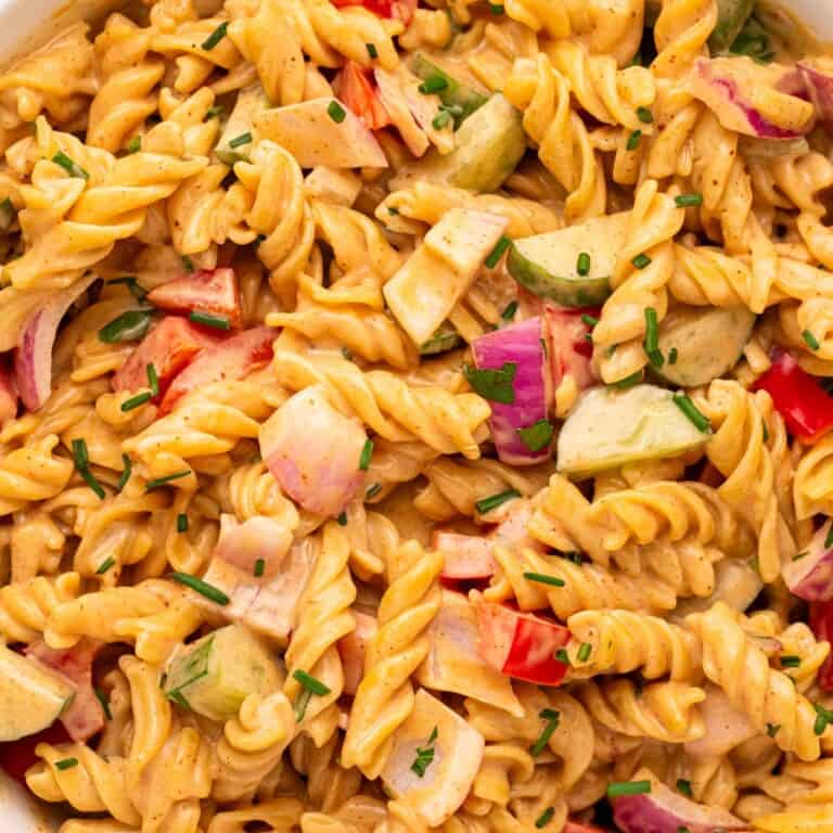 Creamy BBQ pasta salad with rotini, fresh vegetables, and herbs in a creamy BBQ dressing