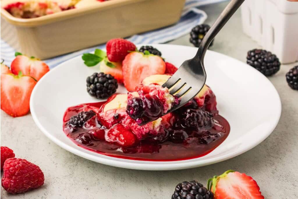 Warm vegan berry cobbler with mixed berries and tender topping