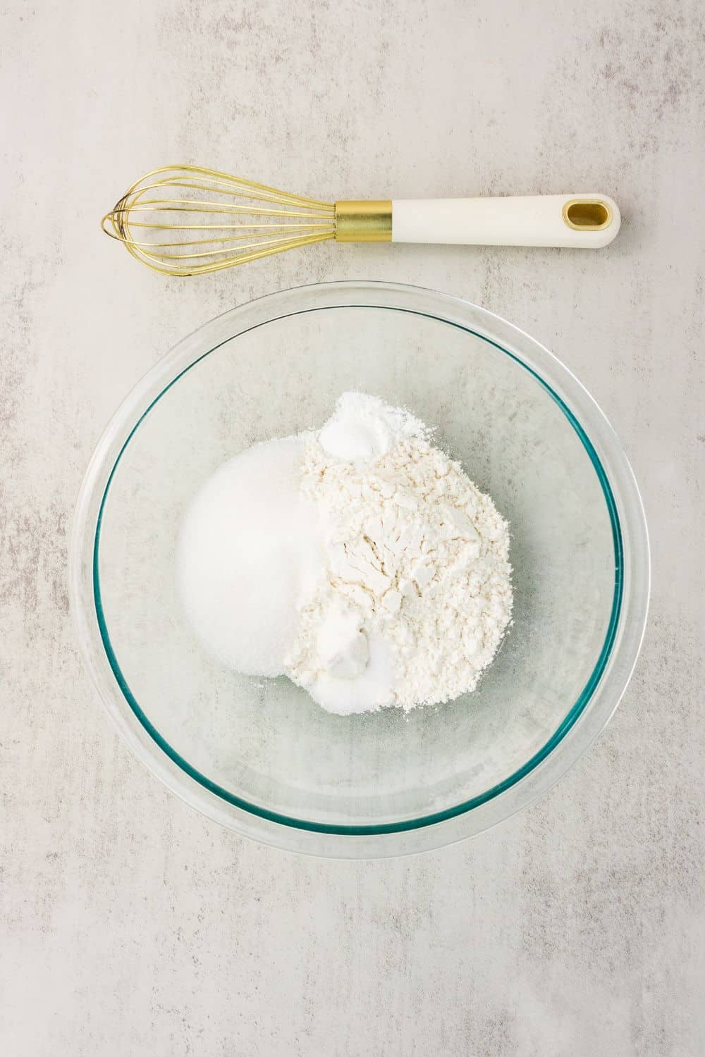 Gluten free flour, sugar, baking powder, and salt whisked together in a glass bowl