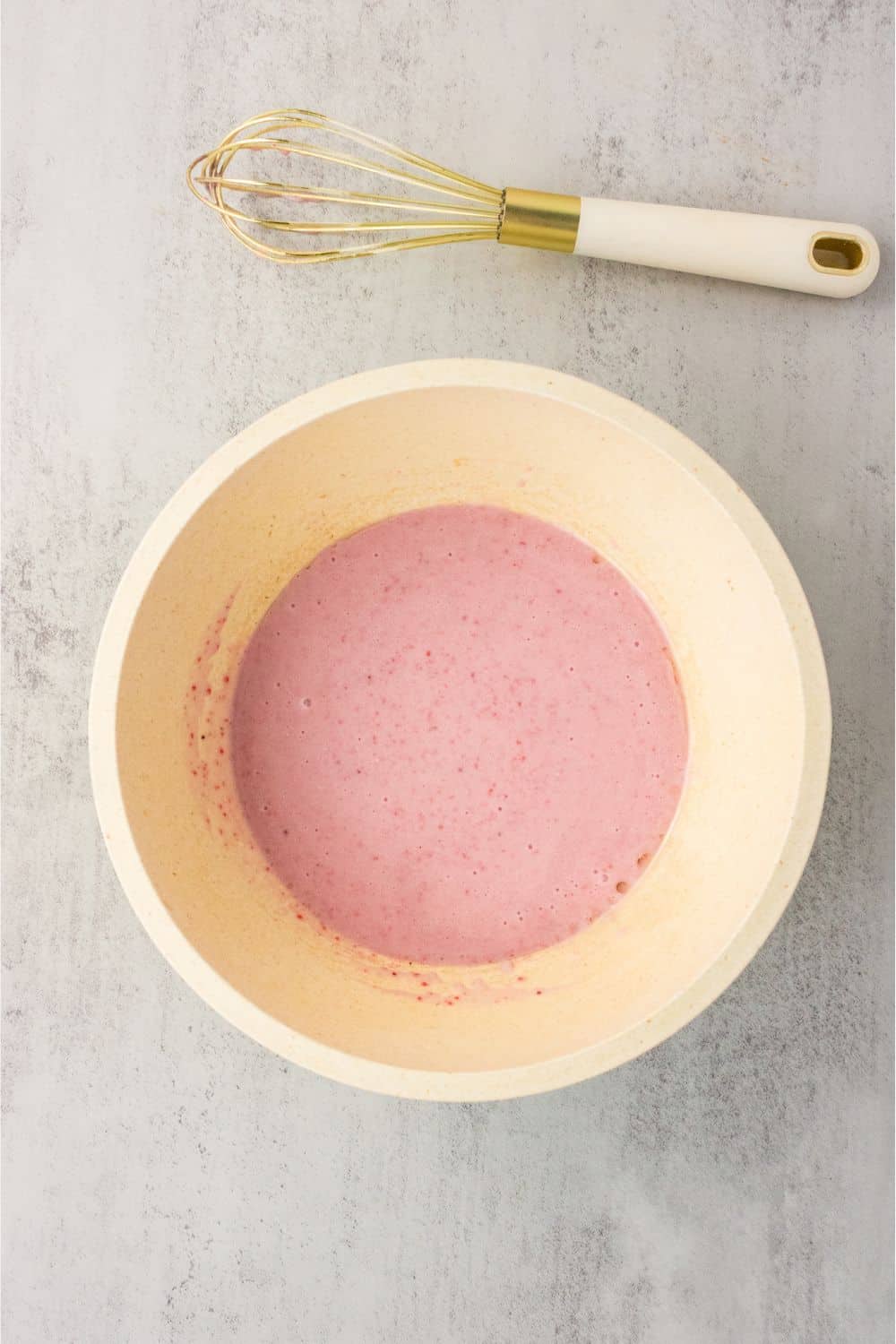 Pink strawberry purée and dairy-free milk wet ingredients whisked together