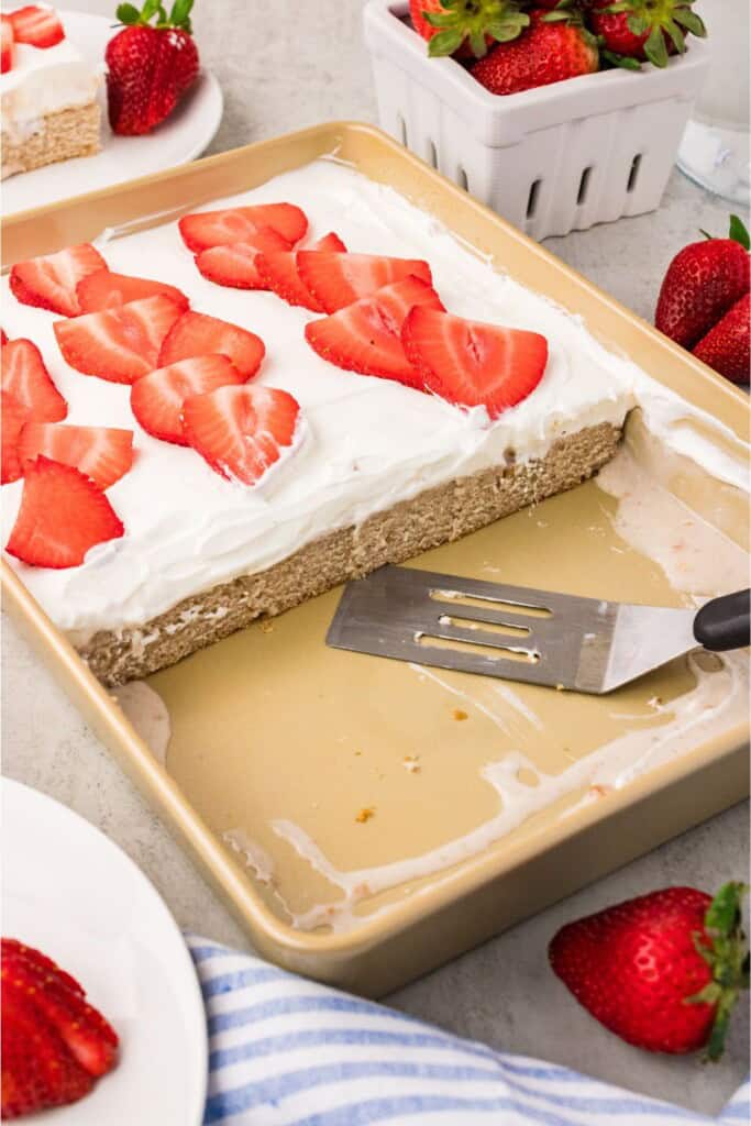Fresh strawberry cake cut into slices showing the soaked interior