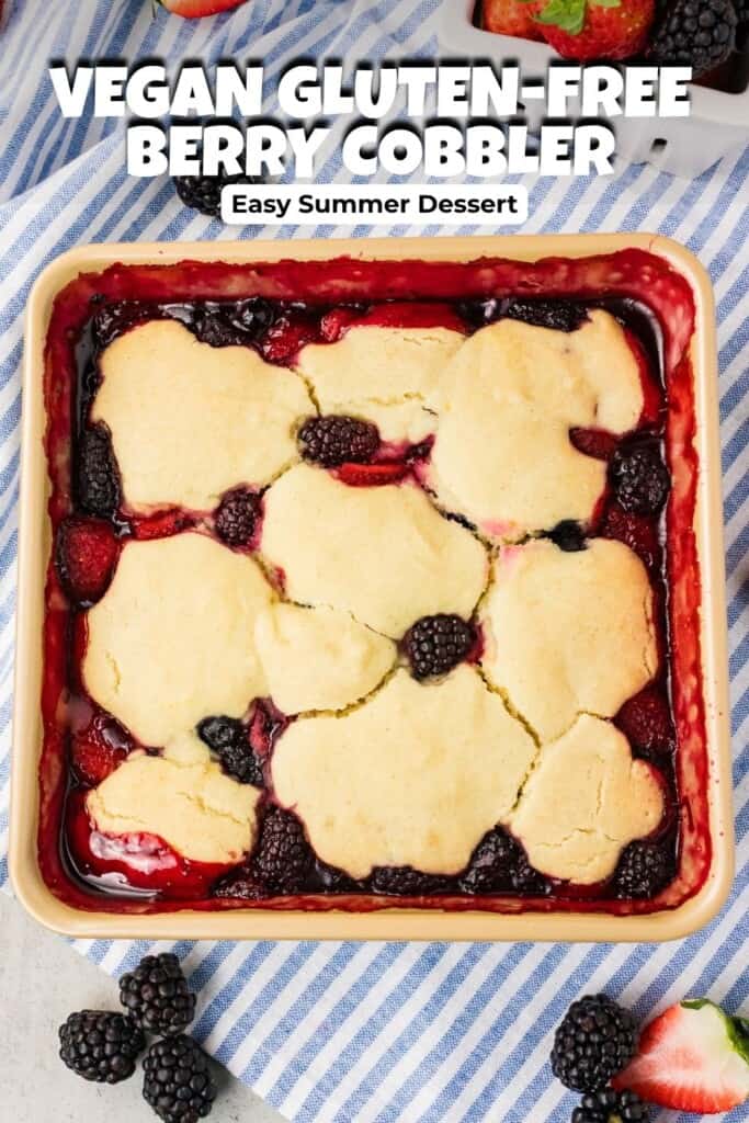 Vegan gluten free berry cobbler in a baking pan with golden topping and bubbling mixed berries