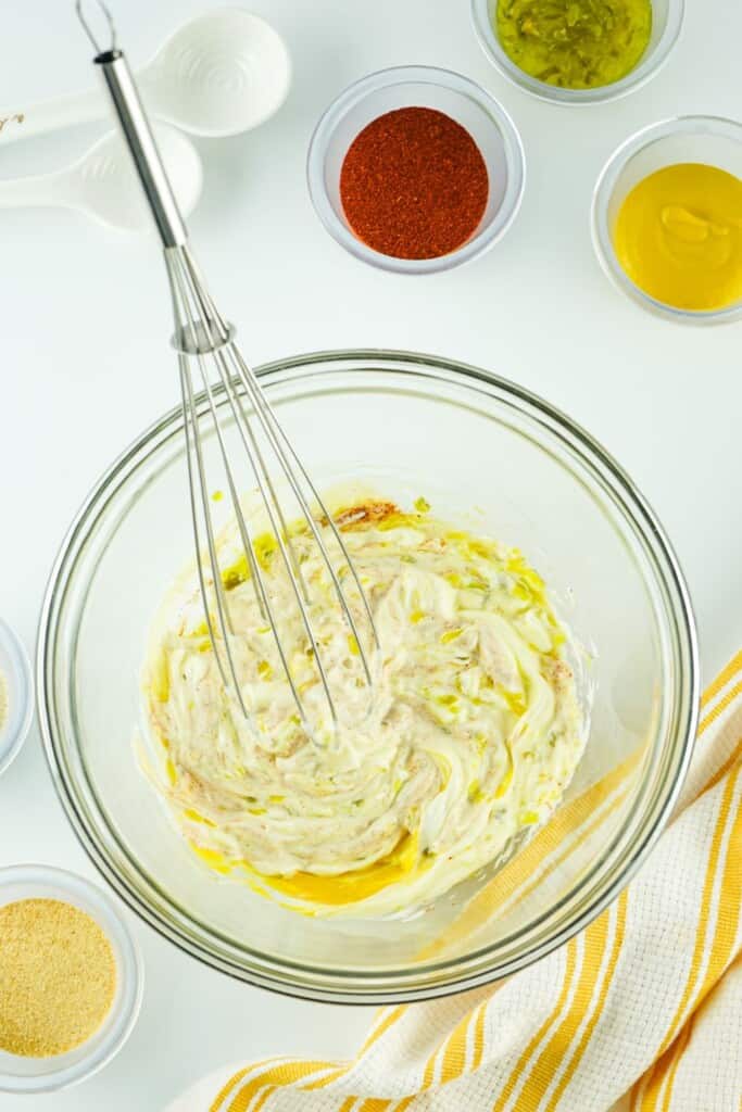 Whisking homemade Big Mac sauce in a glass bowl until smooth and creamy