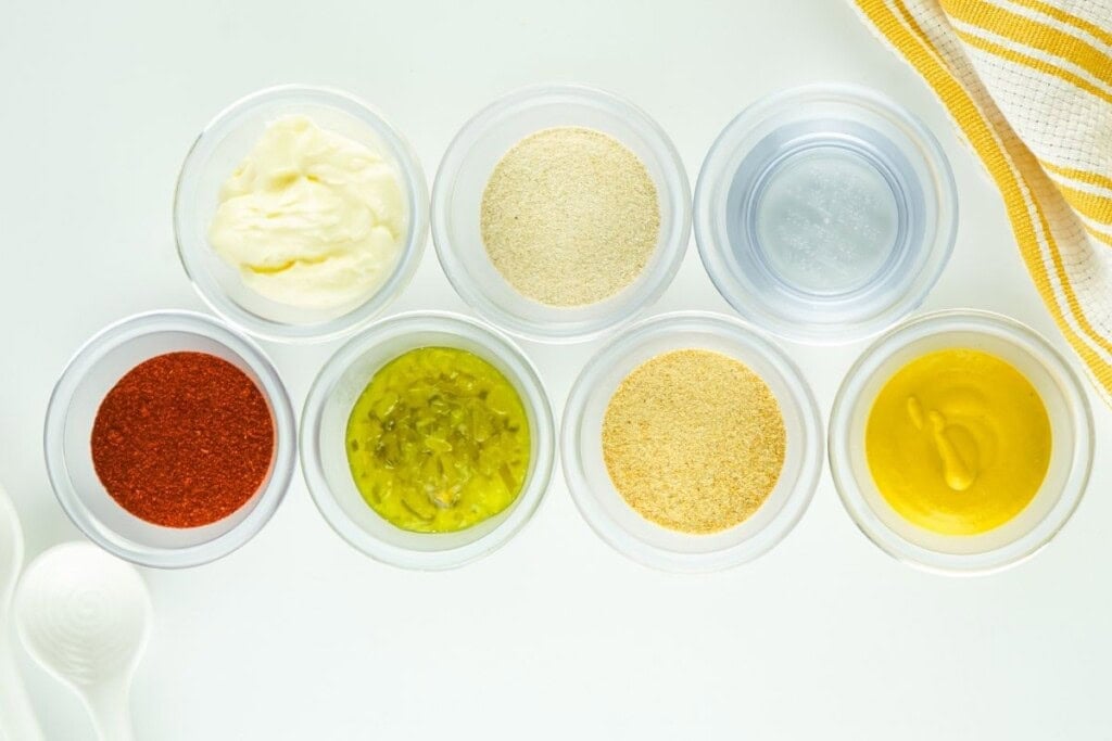 Ingredients for copycat Big Mac sauce in small glass bowls including mayonnaise, sweet relish, yellow mustard, paprika, onion powder, garlic powder, and vinegar