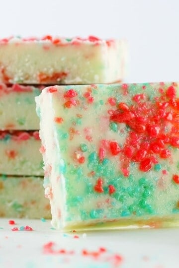 firecracker fudge featured photo, stacked fudgew ith a fudge square set in front of it