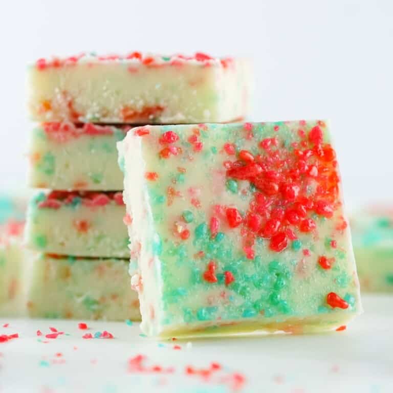 firecracker fudge featured photo, stacked fudgew ith a fudge square set in front of it