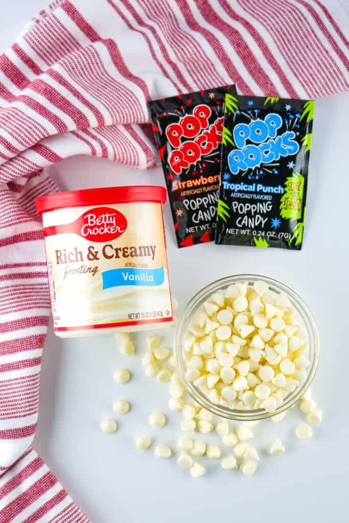 Ingredients for firecracker fudge: white frosting, white chocolate chips, and Pop Rocks