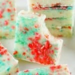 A piece of firecracker fudge with a bite taken out showing the creamy white center