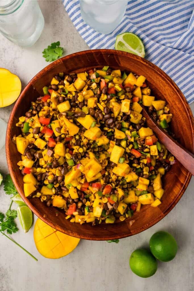 mango black bean salad in a large wooden serving bowl