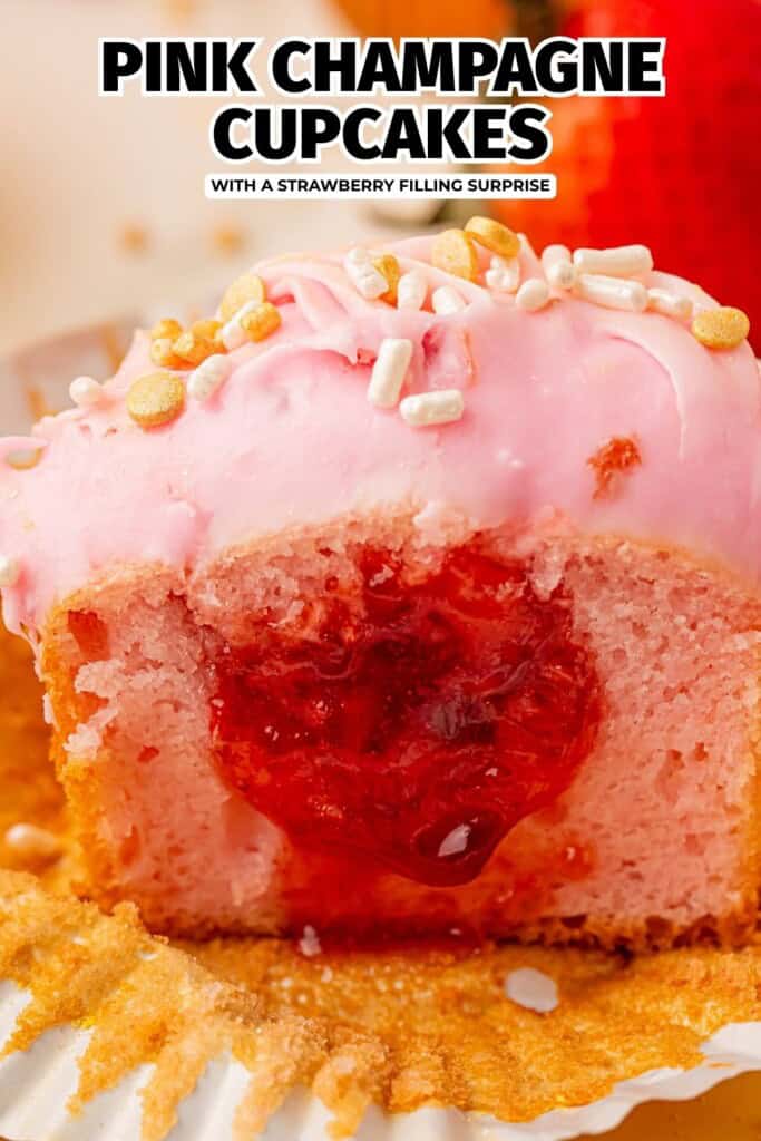 pink champagne strawberry cupcake cut in half showing strawberry filling