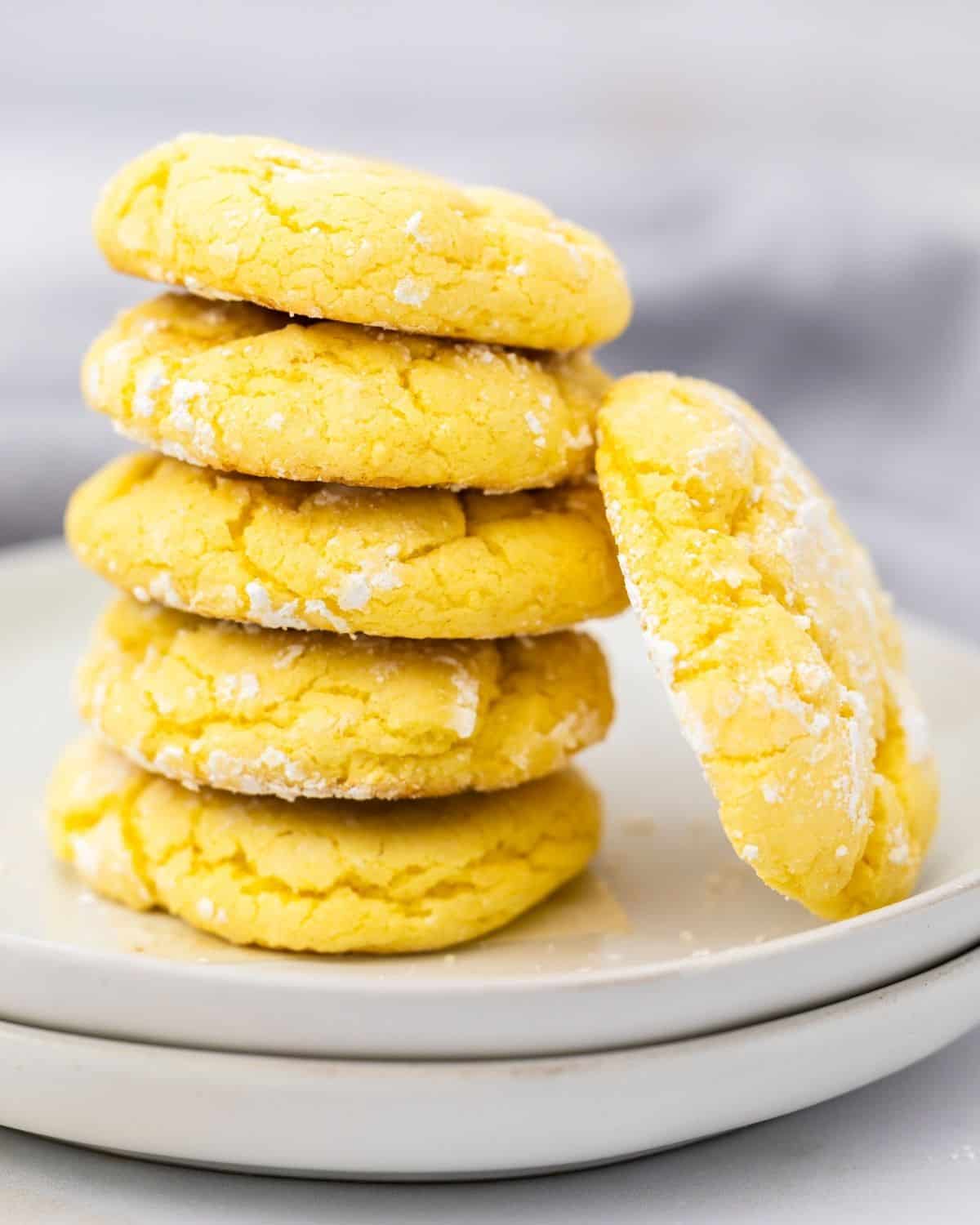 Stack of soft lemon crinkle cookies made with cake mix on a white plate