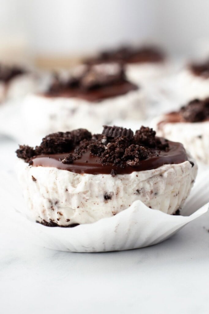 Easy mini Oreo cheesecakes in cupcake liners on a marble counter