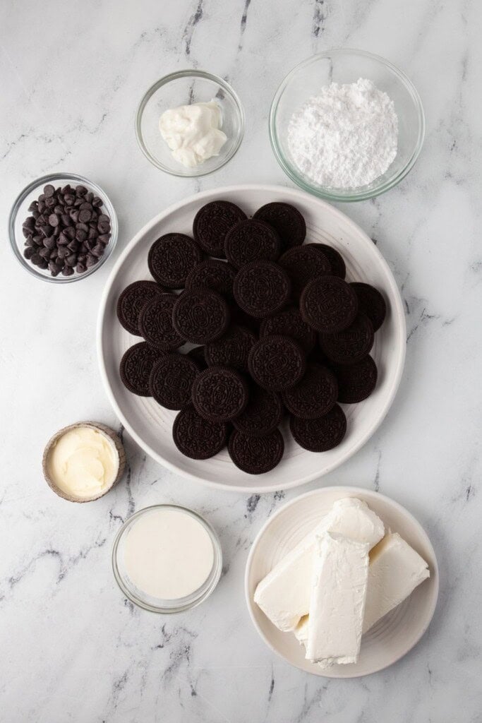 Ingredients for no bake mini Oreo cheesecakes including Oreos, cream cheese, and heavy cream