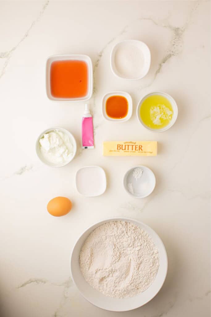 Ingredients for pink champagne cupcakes including rosé, egg whites, and sour cream