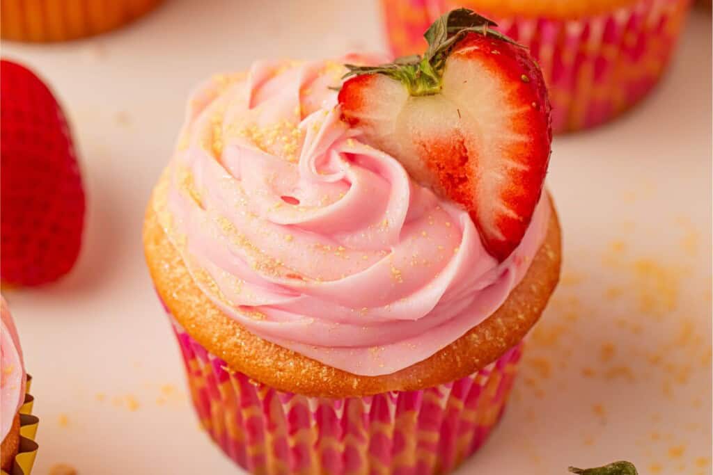 Pink champagne cupcakes with champagne buttercream and heart-shaped strawberry