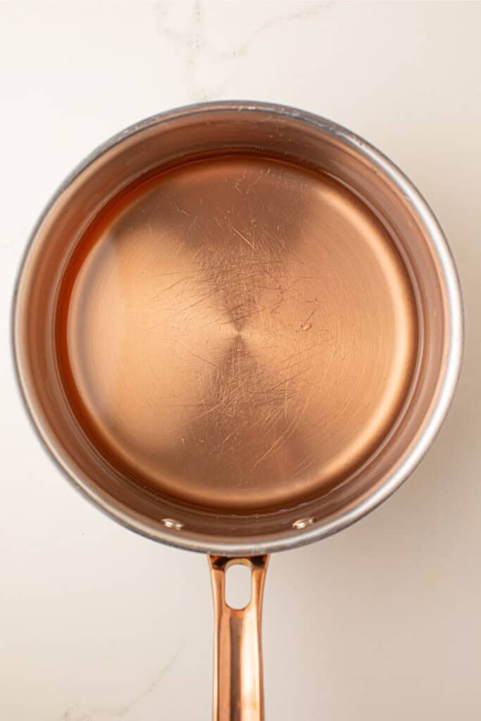 Rosé champagne reduction in a saucepan for champagne cupcakes