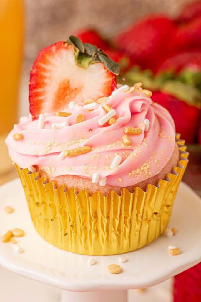 strawberry champagne cupcake with a fresh strawberry on top