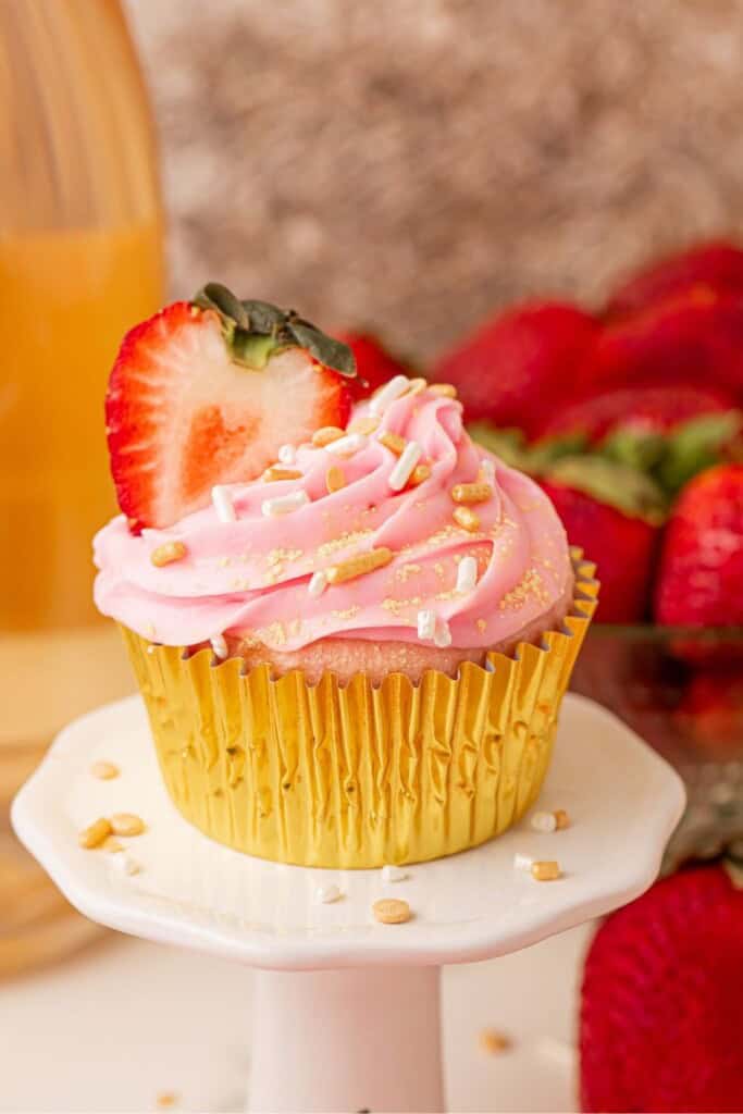 strawberry champagne cupcakes on a cake stand