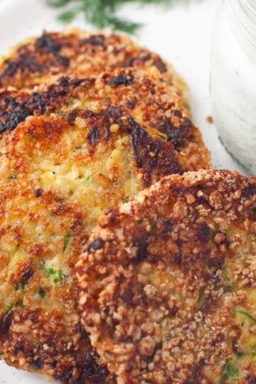 fried zucchini patties with tzatziki sauce featured image