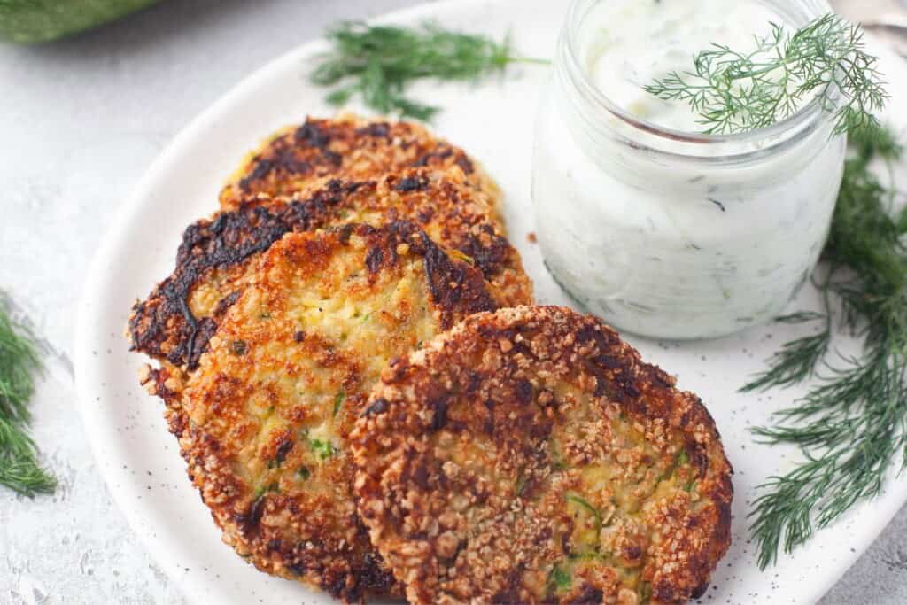 Crispy zucchini patties with feta served with homemade tzatziki sauce