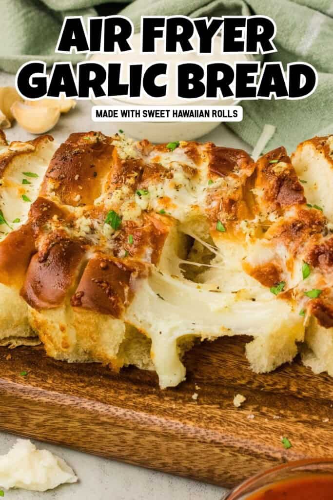 Air fryer Hawaiian roll garlic bread with melted mozzarella cheese pull on a wooden cutting board