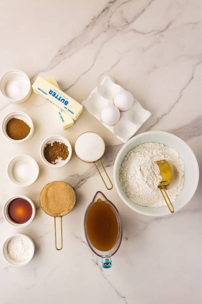 Ingredients for brown butter apple cider snickerdoodles measured into bowls on marble