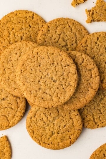 Brown butter apple cider snickerdoodles piled on white marble