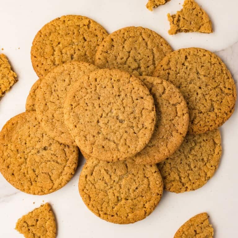 Brown butter apple cider snickerdoodles piled on white marble