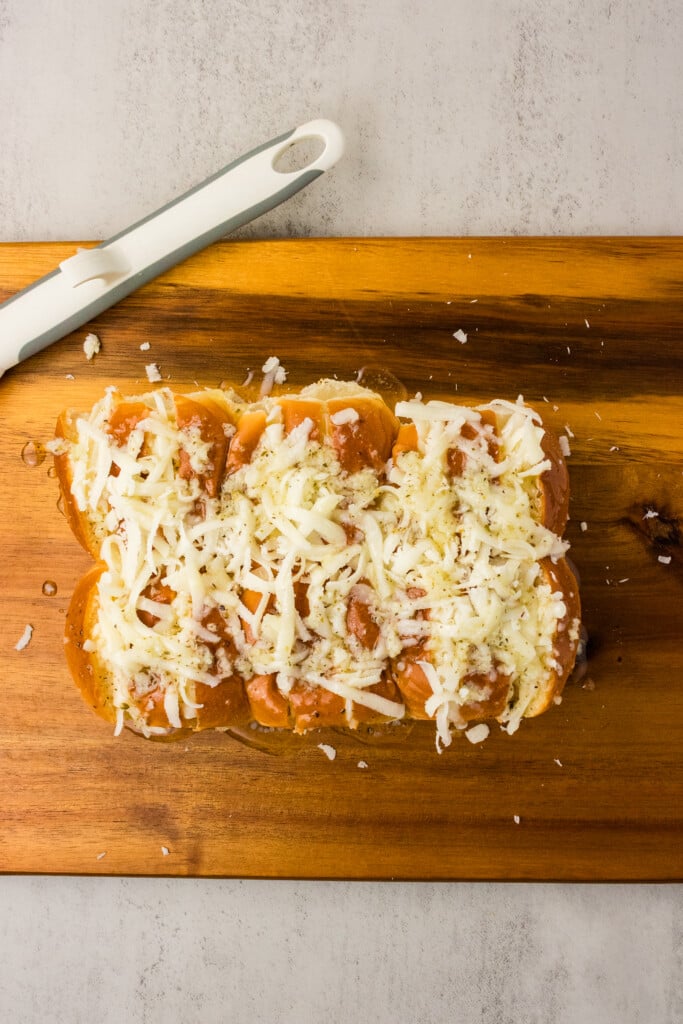 Garlic herb butter brushed over cheese-stuffed Hawaiian rolls before air frying