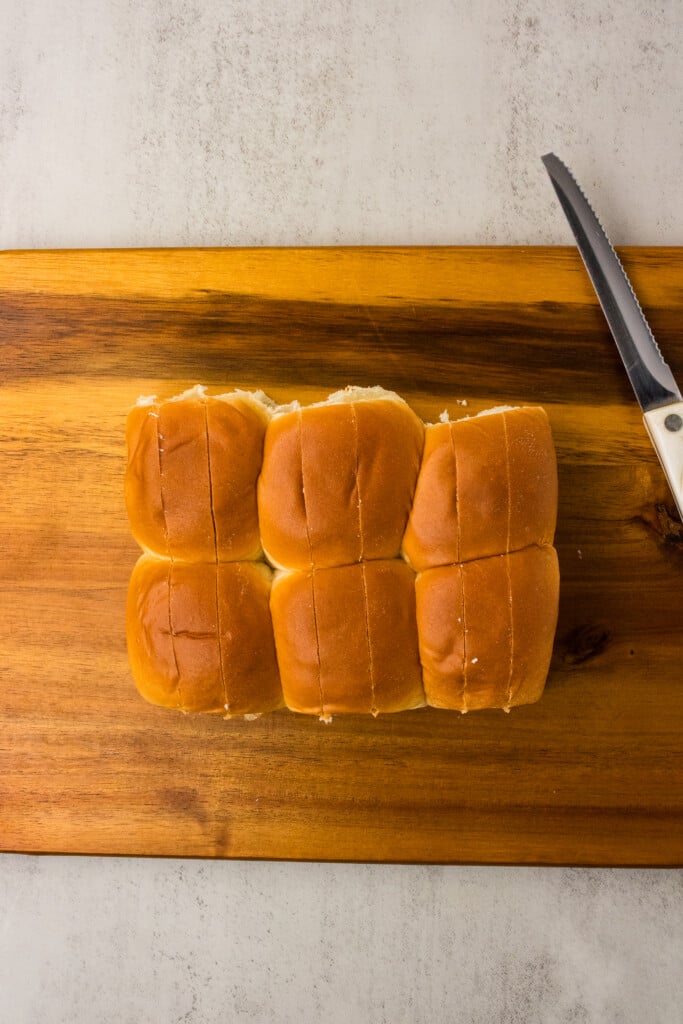 Hawaiian rolls with two lengthwise cuts in each roll for stuffing with cheese